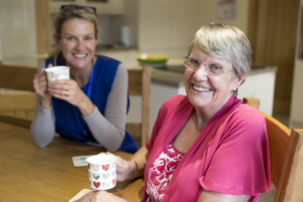 care worker visiting elderly woman for tea