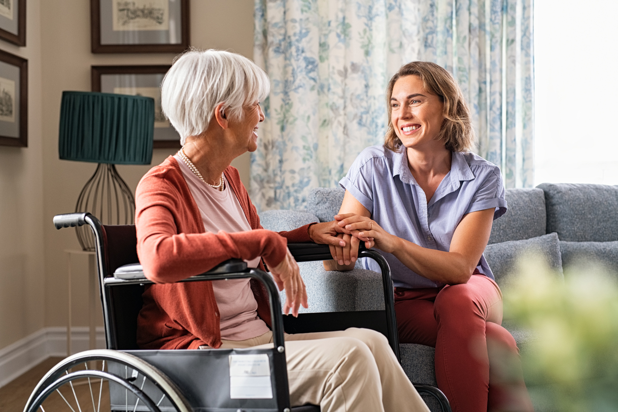 support worker comforting elderly woman at home